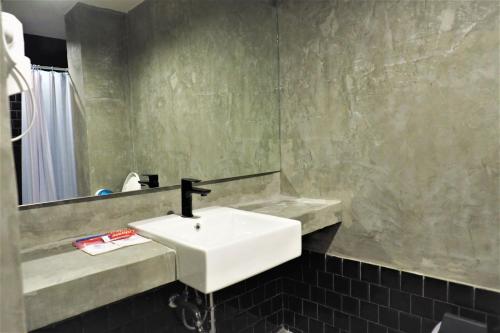 曼谷COZ Ratchathewi的浴室设有白色水槽和镜子