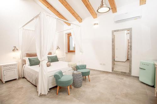 圣特雷莎加卢拉La casa di Memmi Suites & Rooms的一间卧室配有一张床和两把椅子
