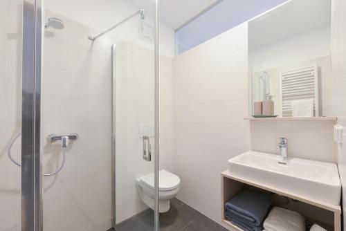 Schwadorf23-hotel的浴室配有卫生间、盥洗盆和淋浴。
