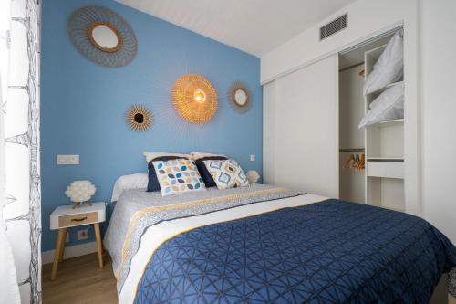 罗什福尔T2 cosy Port de plaisance Parking-wifi gratuit的蓝色的卧室设有一张床,墙上装有镜子
