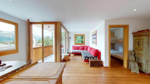 蓬特雷西纳Chavriöl的客厅配有红色的沙发和床。