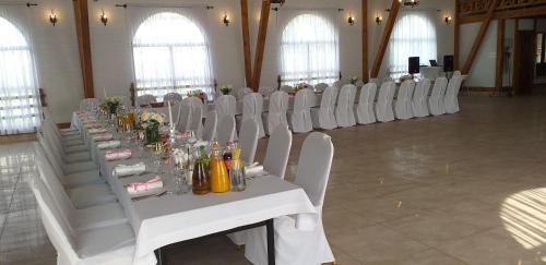 GrochówGrochowiak的大厅里设有白色桌椅的房间