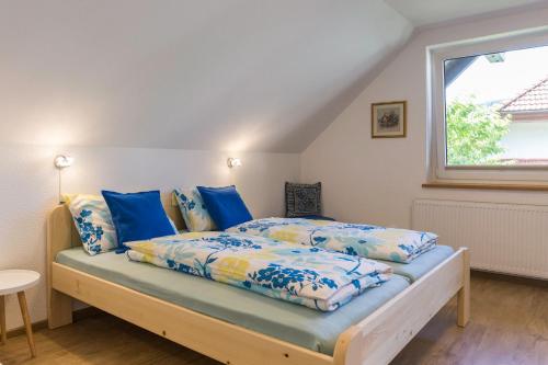 布莱德奥利普公寓的一间卧室配有一张带蓝色床单的床和一扇窗户。