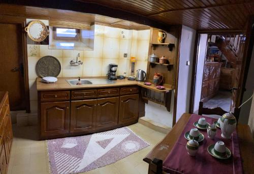 马克里尼撒Arhontiko Theofilos的厨房配有水槽和带杯子的桌子