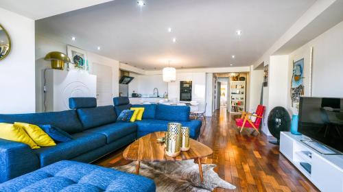 戛纳appartement vue mer的客厅配有蓝色的沙发和桌子