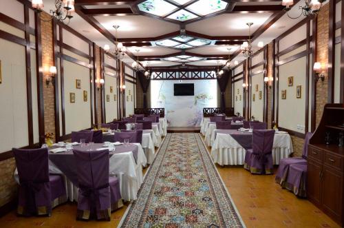 卡拉甘达Hotel Miss Mari的一间设有紫色椅子和屏幕的桌子的房间