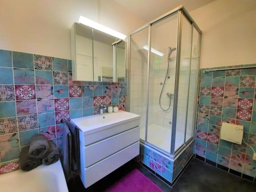 博伊龙FeWo Forstvilla Beuron的带淋浴、水槽和玻璃淋浴间的浴室