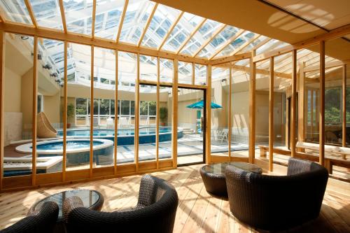 洲本市淡路岛酒店的一个带游泳池和椅子的玻璃房子