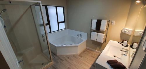 陶波陶波雅坤汽车旅馆的带淋浴、浴缸和盥洗盆的浴室