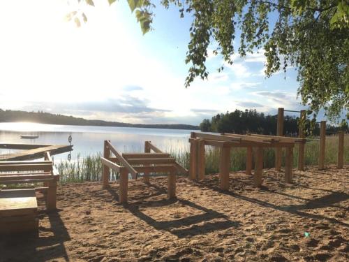 OdensviOdensvi Vandrarhem的两个长椅坐在湖边的沙子里