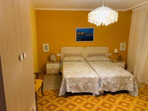 艾利亚德亚罗萨Casa A Confianza的一间卧室配有一张床和一个吊灯