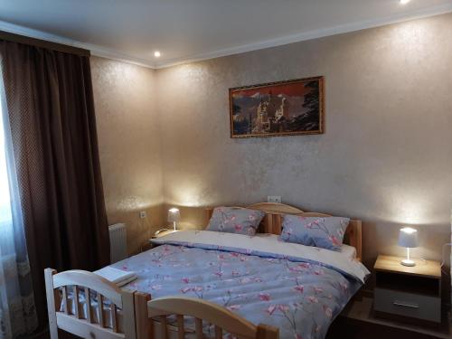 乌曼岛Park Hotel的一间卧室配有一张带蓝色床单的床和两把椅子