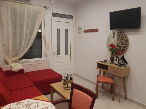 斯卡拉拉乔伊Kohyli Apartments的客厅设有红色的沙发和窗户。