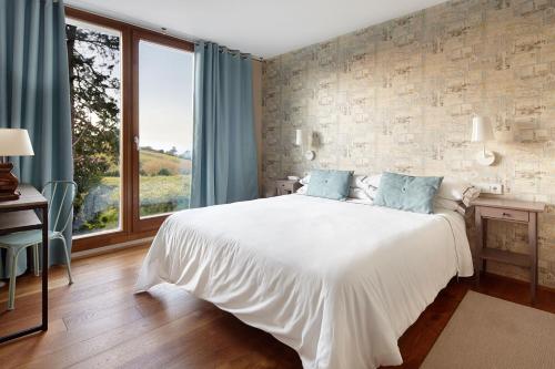 吉塔里亚桑普如登尚酒店的卧室设有白色的床和大窗户