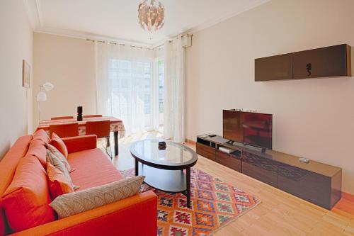 尼斯le capitole的客厅配有红色沙发和电视