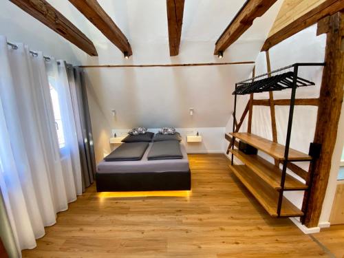 泰克山下基尔夏伊姆Altstadt Apartments的一间卧室配有一张床,铺有木地板