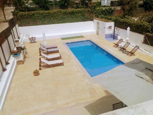科马鲁加Casa Can Miras的享有带躺椅的游泳池的顶部景致