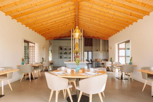 孔波尔塔Spatia Comporta的用餐室设有木制天花板和桌椅