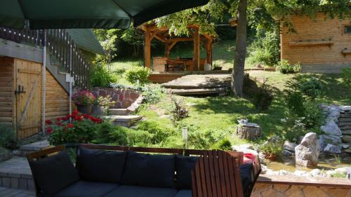 BeočinPlaninska kuća "Zvuk Tišine" - Fruška gora的一个带沙发和遮阳伞的花园