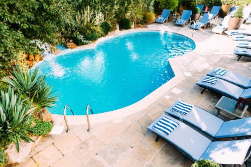 圣赫利尔泽西经典英国泽西俱乐部酒店&SPA的一个带躺椅的游泳池和一个游泳池