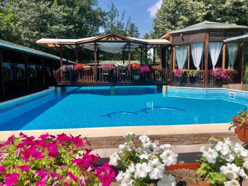 多布里奇家庭酒店的一个带凉亭和鲜花的游泳池