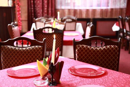 塔古玖Motel Davios的一张红色盘子和蜡烛的桌子