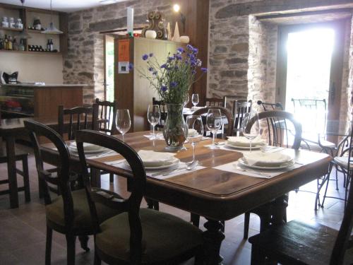 圣埃乌拉利亚德奥斯科斯Casa da Sapeira的用餐室配有桌椅和鲜花