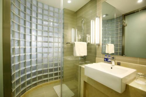 廊坊廊坊远景智选假日酒店的一间带水槽和玻璃淋浴的浴室