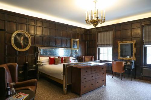 伦敦温布尔登杜文堪尼扎罗之家酒店的卧室配有一张床、一张桌子和椅子