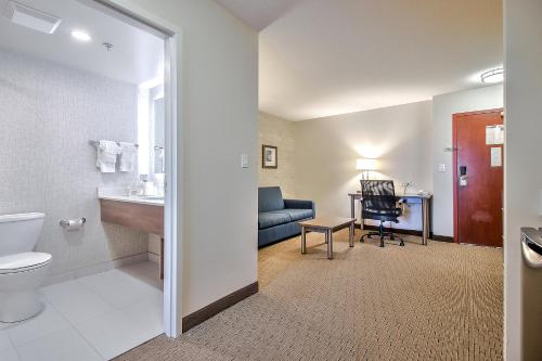 卡尔加里康福特茵南部酒店&套房的一间带卫生间、水槽和沙发的浴室