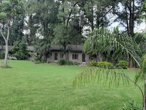 上瓦特法尔Wayside Lodge的绿色草坪庭院内的房子