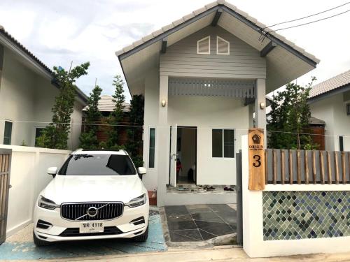 华欣Origin hua hin poolvilla的停在房子前面的白色汽车