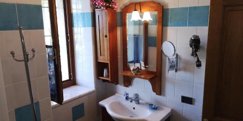 拉达-因基安蒂桑图贝托乡村别墅酒店的一间带水槽和镜子的浴室