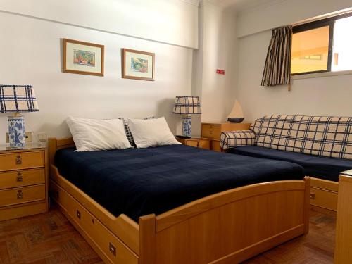 维拉摩拉Discovery Apartment Vilamoura的一间带两张床和一张沙发的卧室