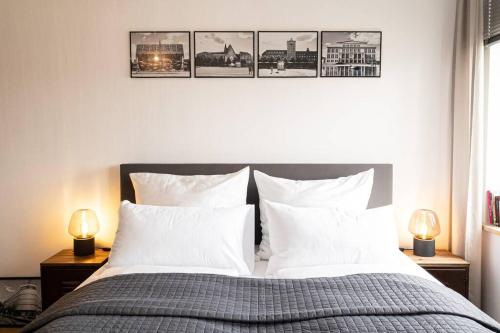 莱比锡Luxus-Apartment in Leipzig mit Privat-Parkplatz的卧室配有一张四幅画的墙壁床。