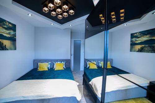 托伦Markiz Apartments的一间卧室配有两张双层床,拥有蓝色的灯光