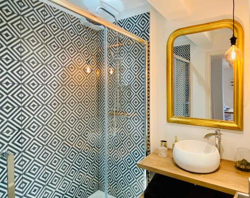 利雪EL PARADISE - Coeur de Ville et Basilique au Balcon的浴室配有盥洗盆和带镜子的淋浴