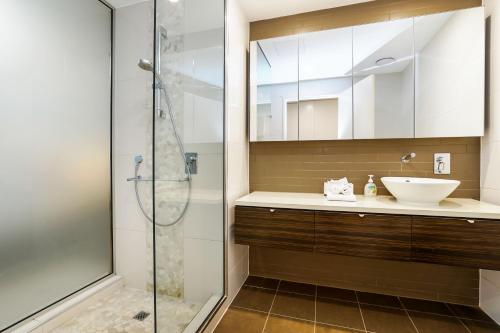 达尔文达尔文海滨豪华套房酒店的一间带水槽和淋浴的浴室