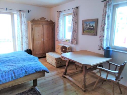 隆高地区圣玛格丽滕Country Appartement Lungau的卧室配有一张床和一张桌子及椅子