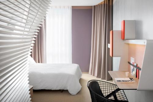 南特南特城堡奥考酒店的酒店客房,配有白色的床和椅子