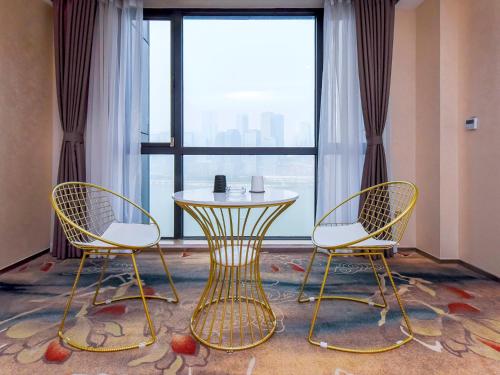 重庆重庆偶然间江景酒店（洪崖洞店）的窗前的两把椅子和一张桌子