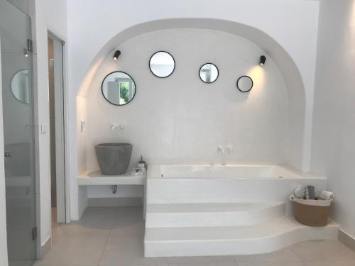 纳乌萨Quartano Luxury Cycladic Residence, Adults Only (13+)的白色的浴室设有浴缸和两面镜子