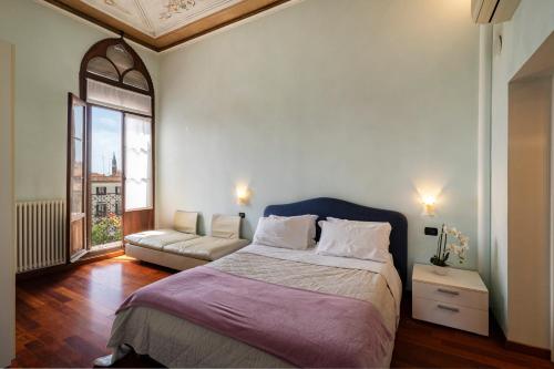 威尼斯莫罗西尼总督宫公寓的一间卧室配有一张大床和一张沙发