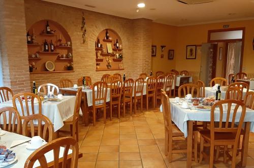 Alberuela de la Liena卡萨卡斯特罗旅馆的一间设有白色桌椅的用餐室