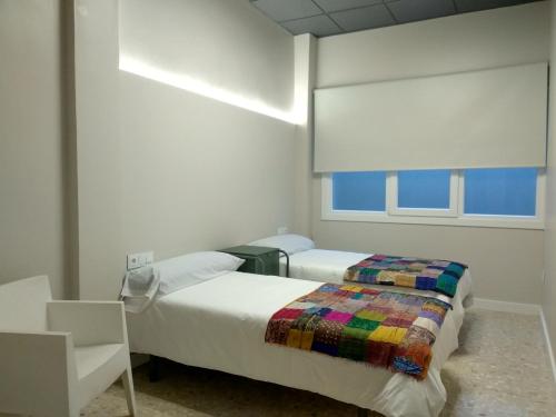 Acolá Rooms客房内的一张或多张床位