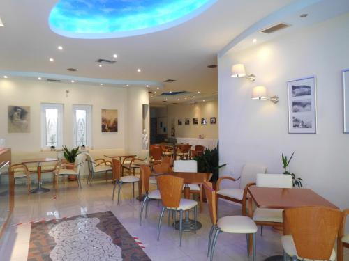 卢特拉艾季普苏Efstratios Hotel的一间在房间内配有桌椅的餐厅