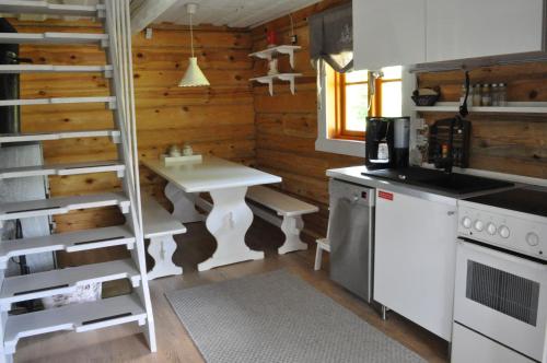 KihelkonnaVilla Verde的厨房配有白色的桌子和梯子
