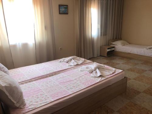 帕莫瑞Stoyko's Guest House的一间卧室配有两张带毛巾的床