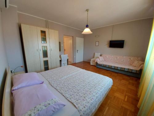 木洛希尼Kuća Luce的一间带两张床和一张沙发的卧室