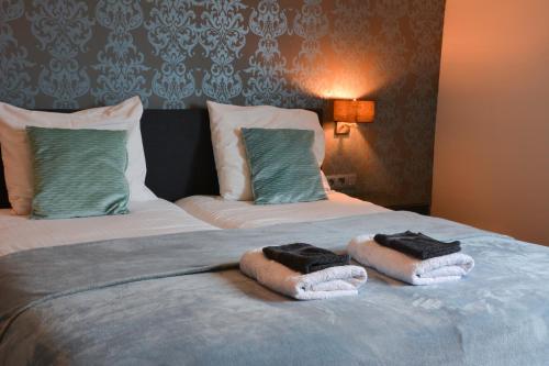 佐内贝克阿布罗狄B＆B住宿加早餐酒店的一间卧室配有带毛巾的床